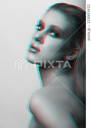 Beautiful woman with fancy make-up and naked shoulder studio portrait in RGB color split effect Beautiful woman with fancy make-up and naked shoulder studio portrait in RGB color split effect 129903452
