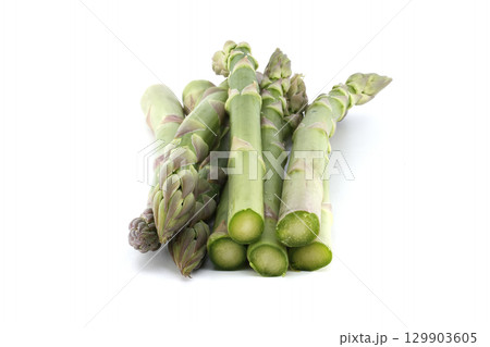 A pile of vibrant, fresh green asparagus on a clean, bright white backdrop. 129903605