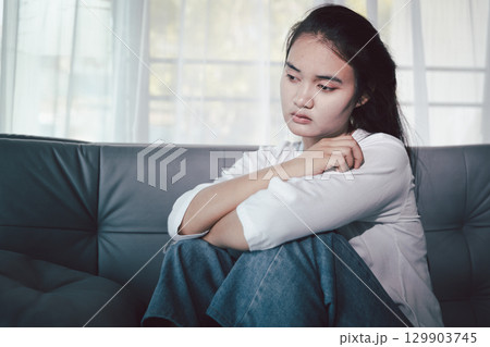 Sorrowful woman sat alone, overwhelmed by emotion, her sad and unhappy expression revealing deep despair, stress and distress left feeling depressed. sorrowful sad, despair alone, depressed stress Sorrowful woman sat alone, overwhelmed by emotion, her sad and unhappy expression revealing deep despair, stress and distress left feeling depressed. sorrowful sad, despair alone, depressed stress 129903745