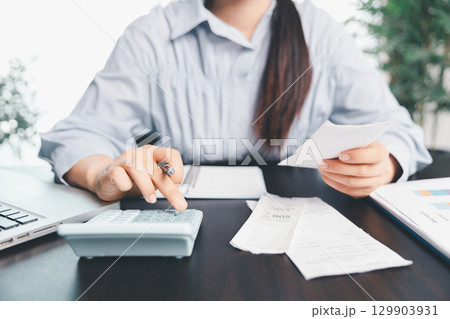 Business woman analyze calculate company financial, tax results office accounting statistics analytical research. calculating business balance prepare tax reduction. Tax deduction planning concept. 129903931
