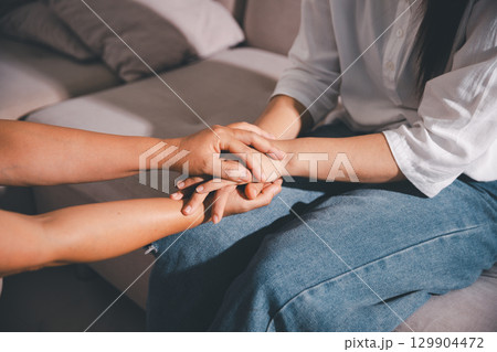 Moment of deep grief, sorrow and anxiety, lonely person overwhelmed by despair feels spark of hope when helping hand reaches out with genuine emotion to ease their problem. Moment of deep grief, sorrow and anxiety, lonely person overwhelmed by despair feels spark of hope when helping hand reaches out with genuine emotion to ease their problem. 129904472