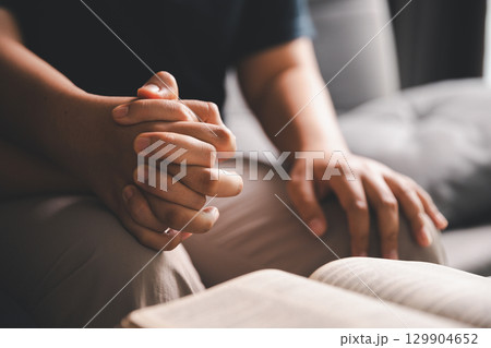 Hope and trust with crisis concept. Closeup, love and holding hands for support, comfort and care with grief, loss and empathy. people and family with compassion, sympathy and healing with bonding. 129904652