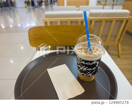 Refreshing Iced Coffee Beverage Served on a Tray in a Cafe Setting Refreshing Iced Coffee Beverage Served on a Tray in a Cafe Setting 129905278