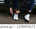 Close-up of the process of tying shoelaces. 129905673