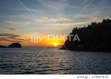 Sunset over Bolilanga Island, Togian archipelago, Sulawesi, Indonesia 129907610