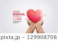 Heart health concept with hand holding red heart, heartbeat line, medical cross and family silhouette symbolizing love, protection, healthcare and wellness. 129908708
