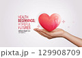 Heart health concept with hand holding red heart, heartbeat line, medical cross and family silhouette symbolizing love, protection, healthcare and wellness. 129908709