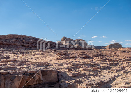 Exploring the rugged terrain of Tsvetnoy Canyon in Egypt during a clear daytime sky Exploring the rugged terrain of Tsvetnoy Canyon in Egypt during a clear daytime sky 129909461
