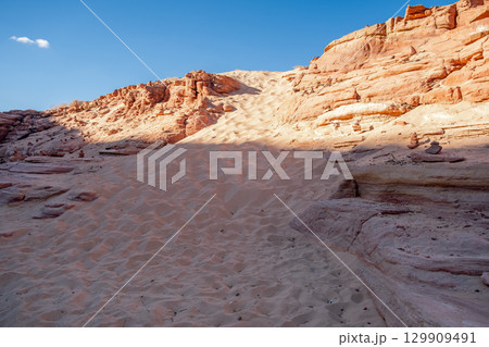 Explore Tsvetnoy Canyon in Egypt during a clear day with stunning rock formations and sandy terrain Explore Tsvetnoy Canyon in Egypt during a clear day with stunning rock formations and sandy terrain 129909491