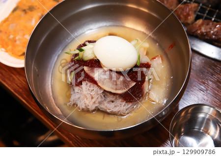 Korean noodle food. Bibim naengmyeon (cold buckwheat noodles) with Korean bbq meat Korean noodle food. Bibim naengmyeon (cold buckwheat noodles) with Korean bbq meat 129909786