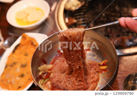 Korean noodle food. Bibim naengmyeon (cold buckwheat noodles) with Korean bbq meat Korean noodle food. Bibim naengmyeon (cold buckwheat noodles) with Korean bbq meat 129909790