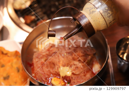 Korean noodle food. Bibim naengmyeon (cold buckwheat noodles) with Korean bbq meat Korean noodle food. Bibim naengmyeon (cold buckwheat noodles) with Korean bbq meat 129909797