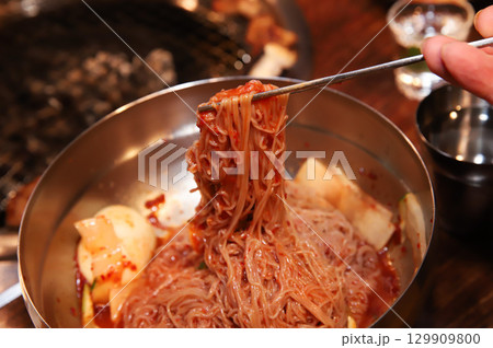 Korean noodle food. Bibim naengmyeon (cold buckwheat noodles) with Korean bbq meat 129909800