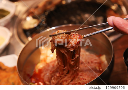 Korean noodle food. Bibim naengmyeon (cold buckwheat noodles) with Korean bbq meat Korean noodle food. Bibim naengmyeon (cold buckwheat noodles) with Korean bbq meat 129909806