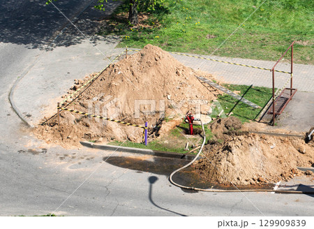 Fire hydrant is in the sewer of the water hatch in the pit. Concept repair on water supply and sewerage, elimination of leakage. Copy space for text, drainage 129909839