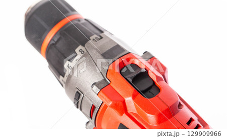 Switch in a modern screwdriver on a drill, close-up. White background, isolate, industry 129909966