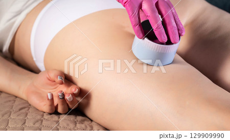Doctor cosmetologist massage therapist does an anti-cellulite relaxing massage on a girl's body, close-up 129909990