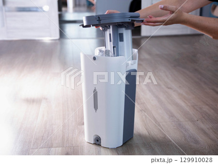 Assembling a bucket with a modern mop with a wringer for easy cleaning. Copy space for text, rinsing the mop 129910028