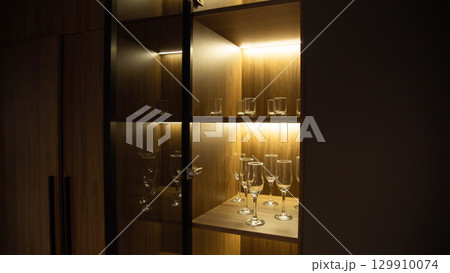Custom cabinet with LED strip in shelves, beautiful design, close-up, technology Custom cabinet with LED strip in shelves, beautiful design, close-up, technology 129910074