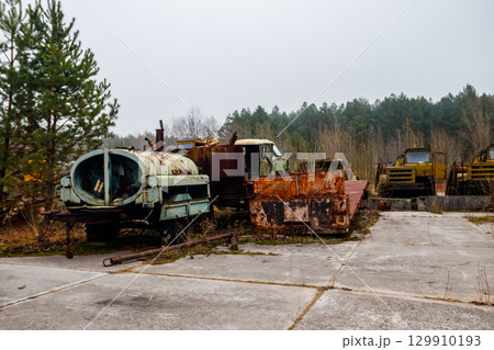 Old rusty abandoned damaged trucks in Chernobyl exclusion zone, Ukraine 129910193