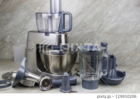 Modern kitchen machine with different attachments and accessories Modern kitchen machine with different attachments and accessories 129910206