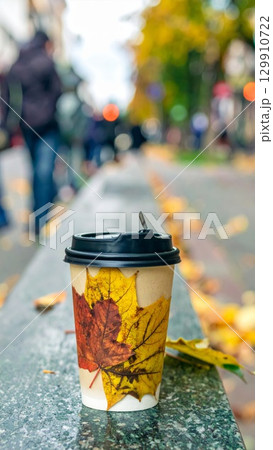 Disposable Coffee Cup with Autumn Leaves Decoration on Street in Daytime Disposable Coffee Cup with Autumn Leaves Decoration on Street in Daytime 129910722