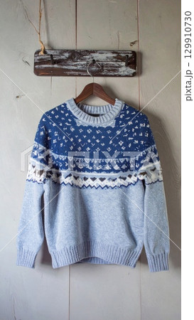 Blue Knitted Sweater Hanging Against Rustic Wooden Background Warm Clothing 129910730