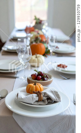 Thanksgiving Table Setting with Pumpkins Gourds and Elegant Festive Autumn Decoration 129910759