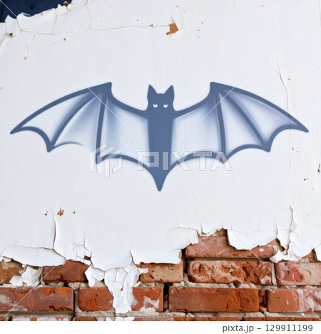 Bat Symbol Graffiti on Distressed Brick and White Plaster Wall Texture 129911199