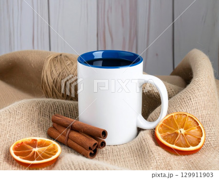 Coffee Mug with Blue Interior and Orange Slices on Burlap Background Still Life 129911903