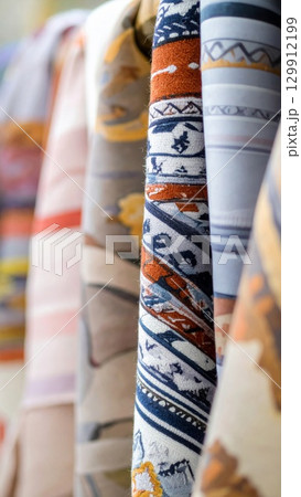 Assorted Colorful Neckties in Display with Intricate Patterns and Textile Designs 129912199