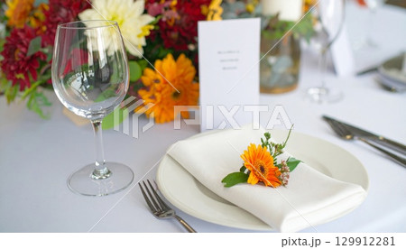 Elegant Table Setting with Floral Decor for Event with Glassware and Cutlery 129912281