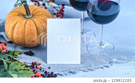Thanksgiving Festive Scene with Pumpkin Red Wine Glasses and a Blank Card 129912283
