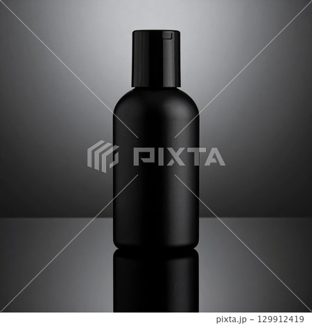Elegant Black Plastic Bottle with Reflected Light and Shadow on Gray Background 129912419