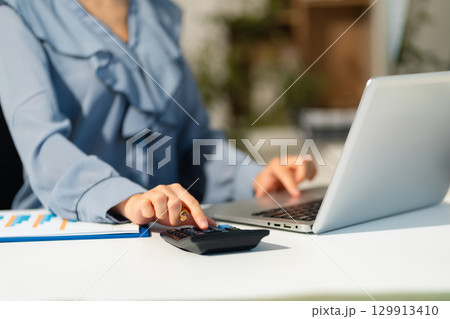 Businesswoman analyzing business enterprise data management, business analytics with charts. Businesswoman analyzing business enterprise data management, business analytics with charts. 129913410