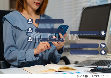 Business woman uses artificial intelligence chatbots automatically respond online messages to help customers instantly. 129913422