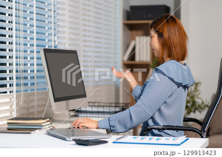 Businesswomen working with smart phone and laptop and digital tablet computer in office. 129913423