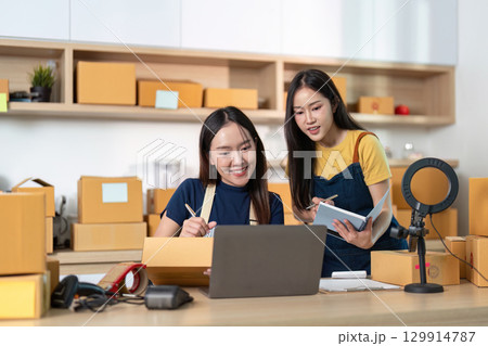 Entrepreneurs discussing strategies and managing inventory in a home office 129914787