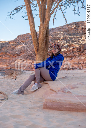 Relaxing by a tree at Tsvetnoy Canyon in Egypt during golden hour 129914817
