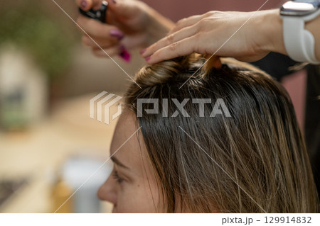 Hair coloring session in a modern salon creating new looks for clients during the afternoon Hair coloring session in a modern salon creating new looks for clients during the afternoon 129914832