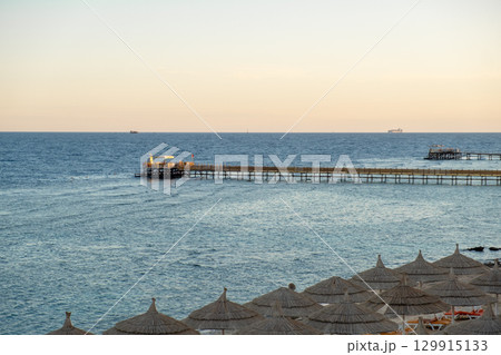 Calm waters and scenic pier at sunset in Egypts coastal region 129915133