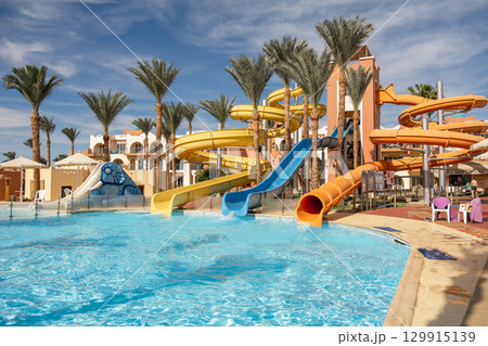 Exciting water slides and tropical scenery at an Egyptian resort in bright sunny weather 129915139