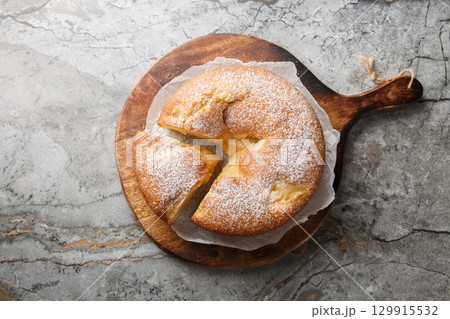 Italian Custard Cake or Torta Nua is a quintessentially dessert known for its minimalistic appearance and decadent flavor closeup on the wooden board. Horizontal top view Italian Custard Cake or Torta Nua is a quintessentially dessert known for its minimalistic appearance and decadent flavor closeup on the wooden board. Horizontal top view 129915532