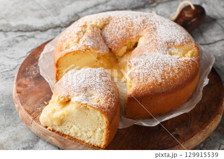 Italian Custard Cake or Torta Nua is a soft Italian cake baked with dollops of Italian pastry cream closeup on the wooden board. Horizontal 129915539