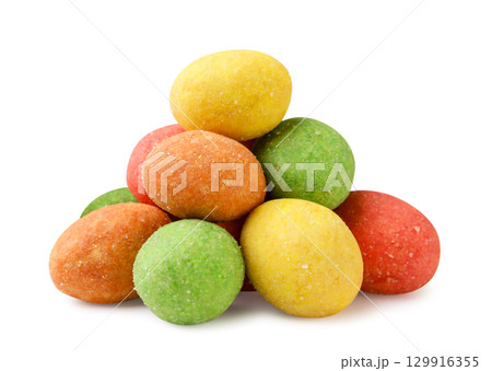 A pile of colorful wasabi peanuts close-up on a white. Isolated 129916355