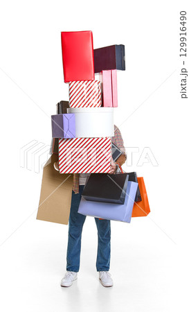 Man overloaded with mountain of shopping boxes and paper bags 129916490