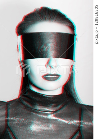 Abstract woman studio portrait with metallic glasses or helmet covering her eyes in RGB color split effect style Abstract woman studio portrait with metallic glasses or helmet covering her eyes in RGB color split effect style 129916505