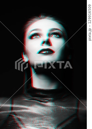 Close-up studio portrait of woman with fancy make-up in RGB color split effect style 129916509