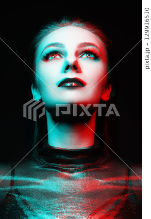 Close-up studio portrait of woman with fancy make-up in RGB color split effect style 129916510