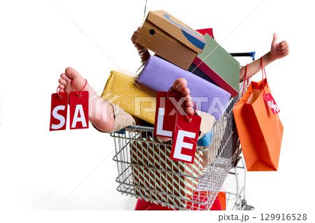 Feet holding red sale tags in shopping cart full of gift boxes Feet holding red sale tags in shopping cart full of gift boxes 129916528